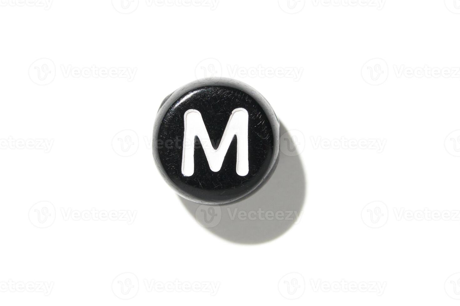 Black keyboard key with letter m isolated on white background with shadow for minimalist design concepts photo