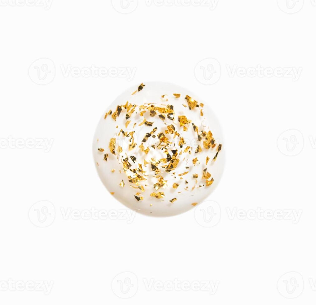 Delicate gold leaf adorned white sphere art capturing minimalist elegance and modern design trends in contemporary art photo