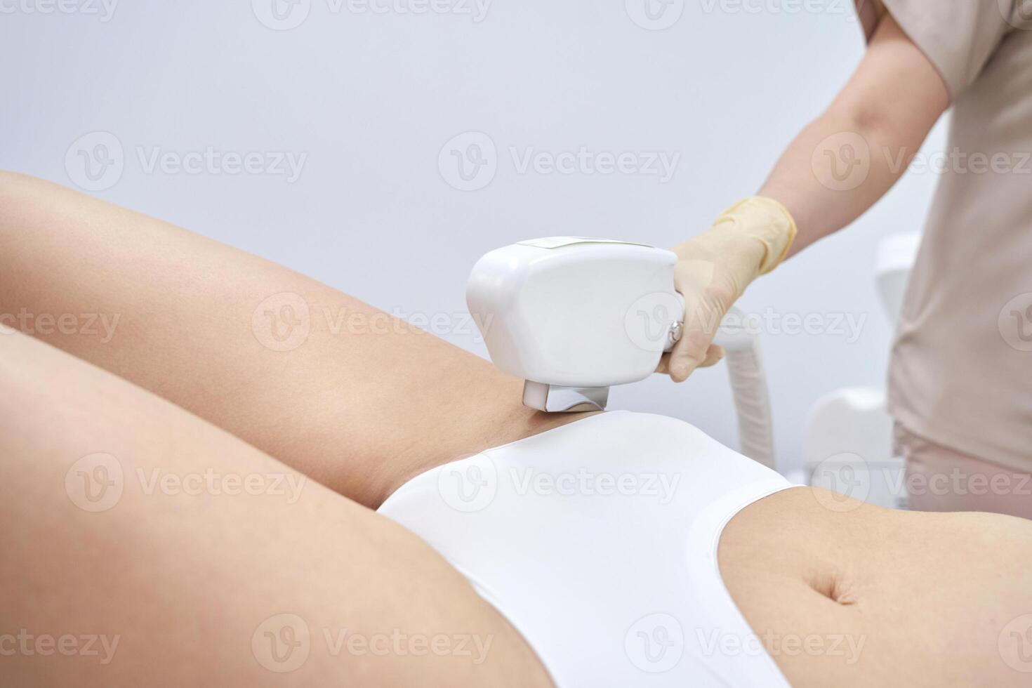 Professional laser hair removal session in beauty clinic for smooth skin care. photo