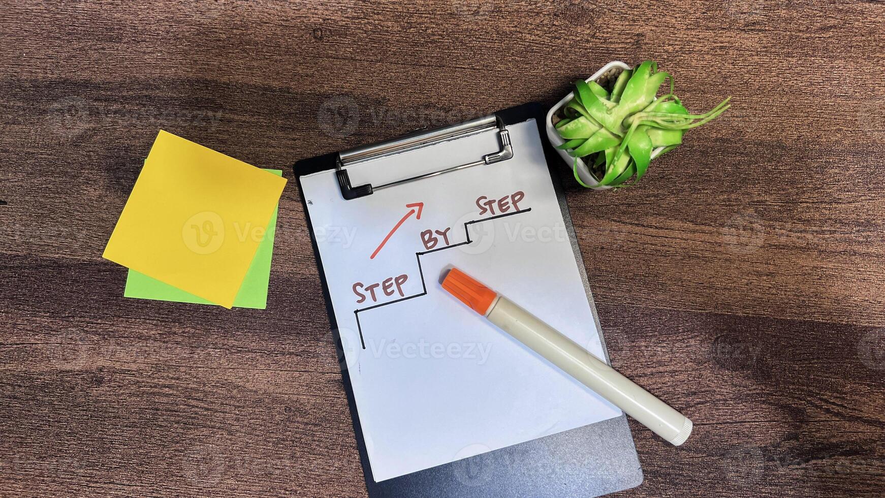 Concept of Step by Step write on paperwork isolated on wooden background. photo