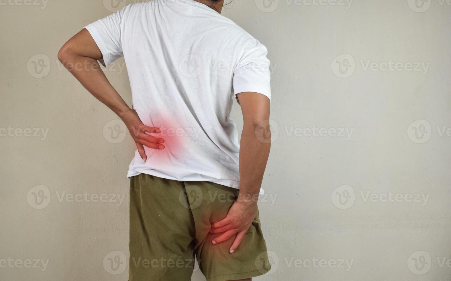 Man feeling nerve pain from lower back and goes down to legs. Sciatica concept photo