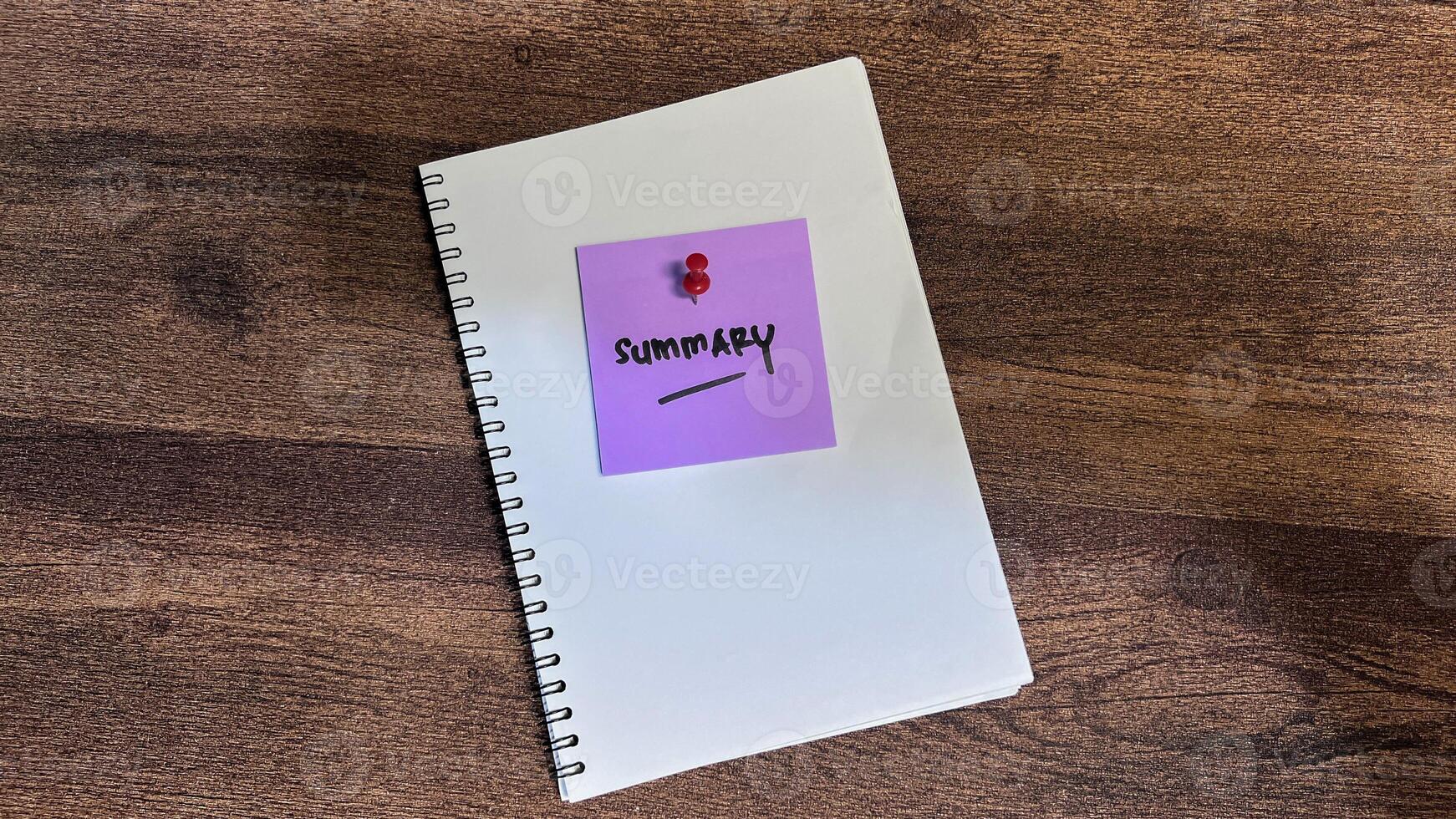 Concept of Summary write on sticky notes isolated on Wooden Table. photo