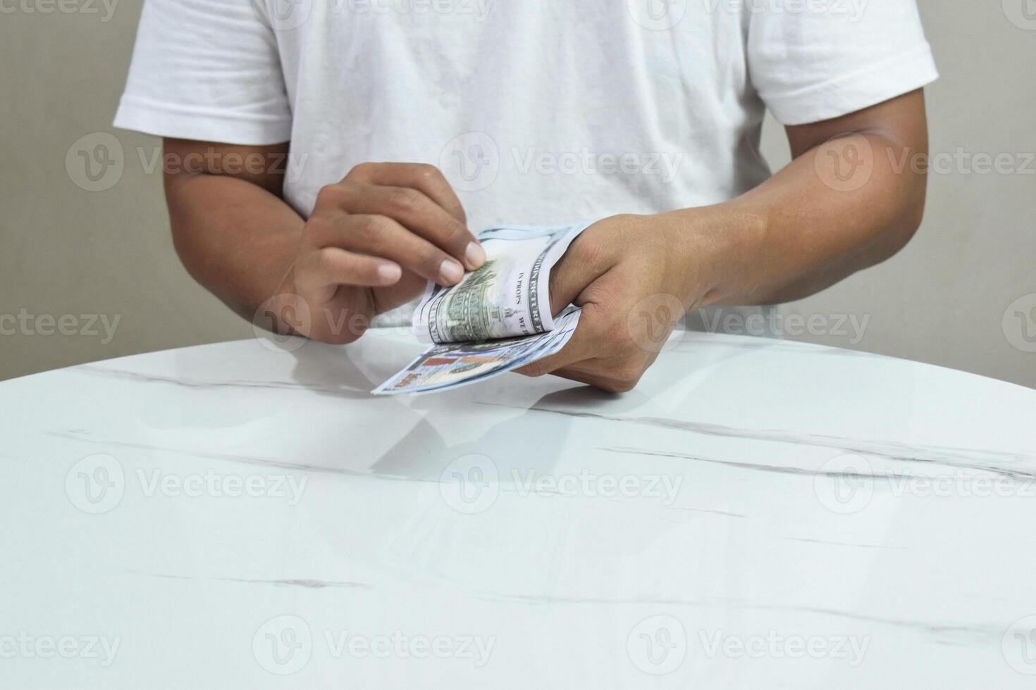 Person's hands holding and counting money in cash photo
