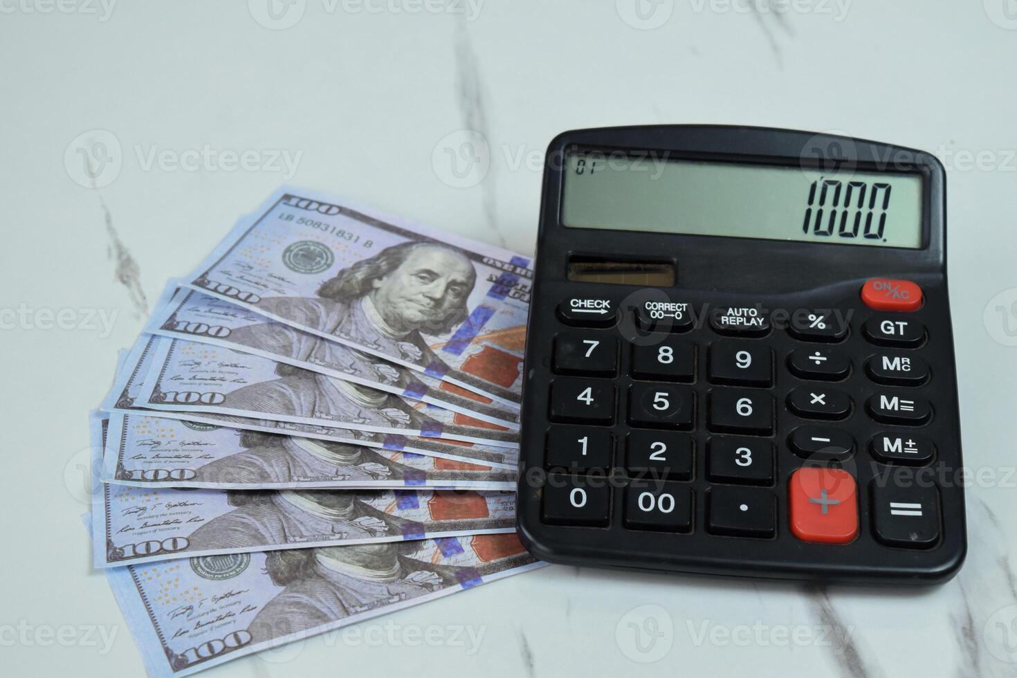 One hundred dollar and calculator on the table, financial management concept photo