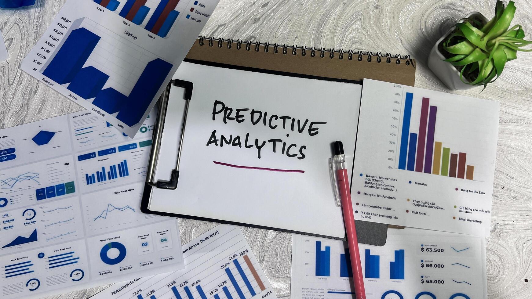 Concept of Predictive Analytics write on paperwork isolated on wooden background. photo