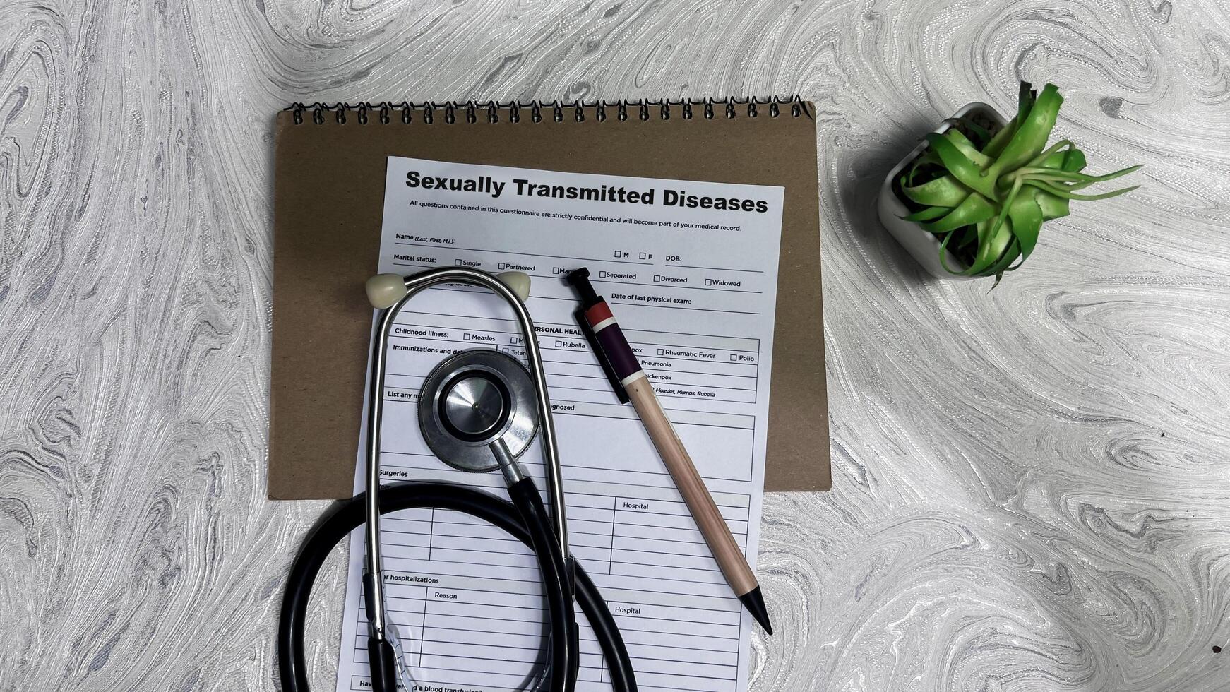 Concept of Sexually Transmitted Diseases write on document isolated on Wooden Table. photo