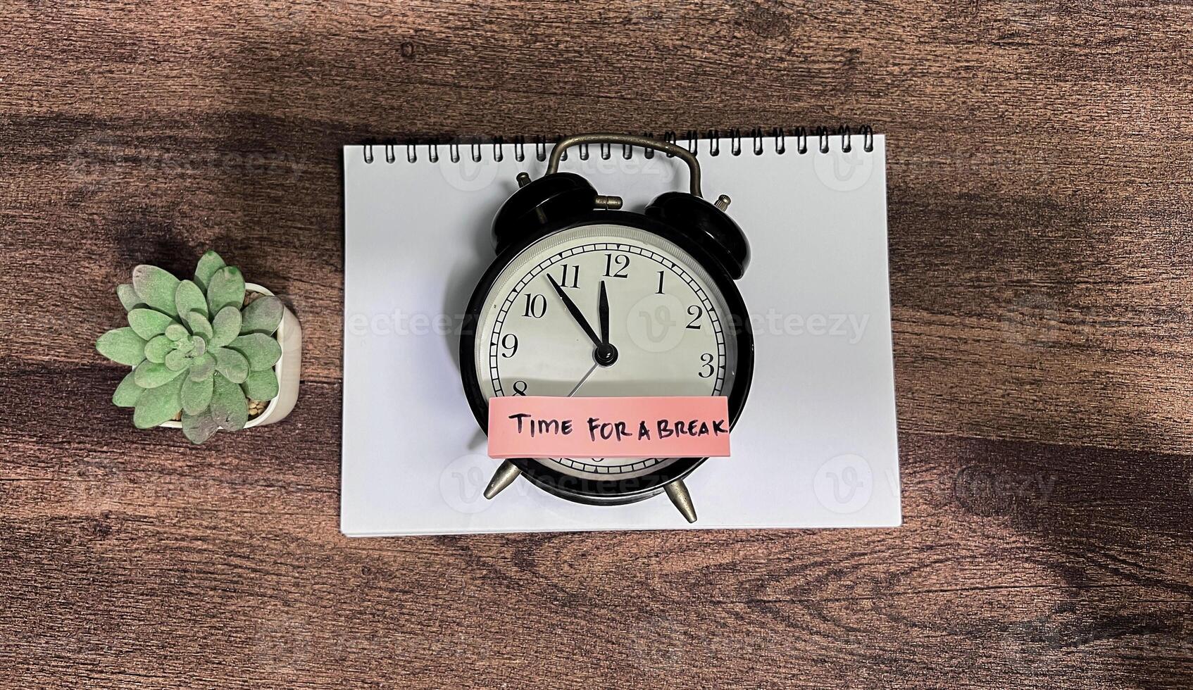 Concept of Time For a Break write on sticky notes isolated on Wooden Table. photo