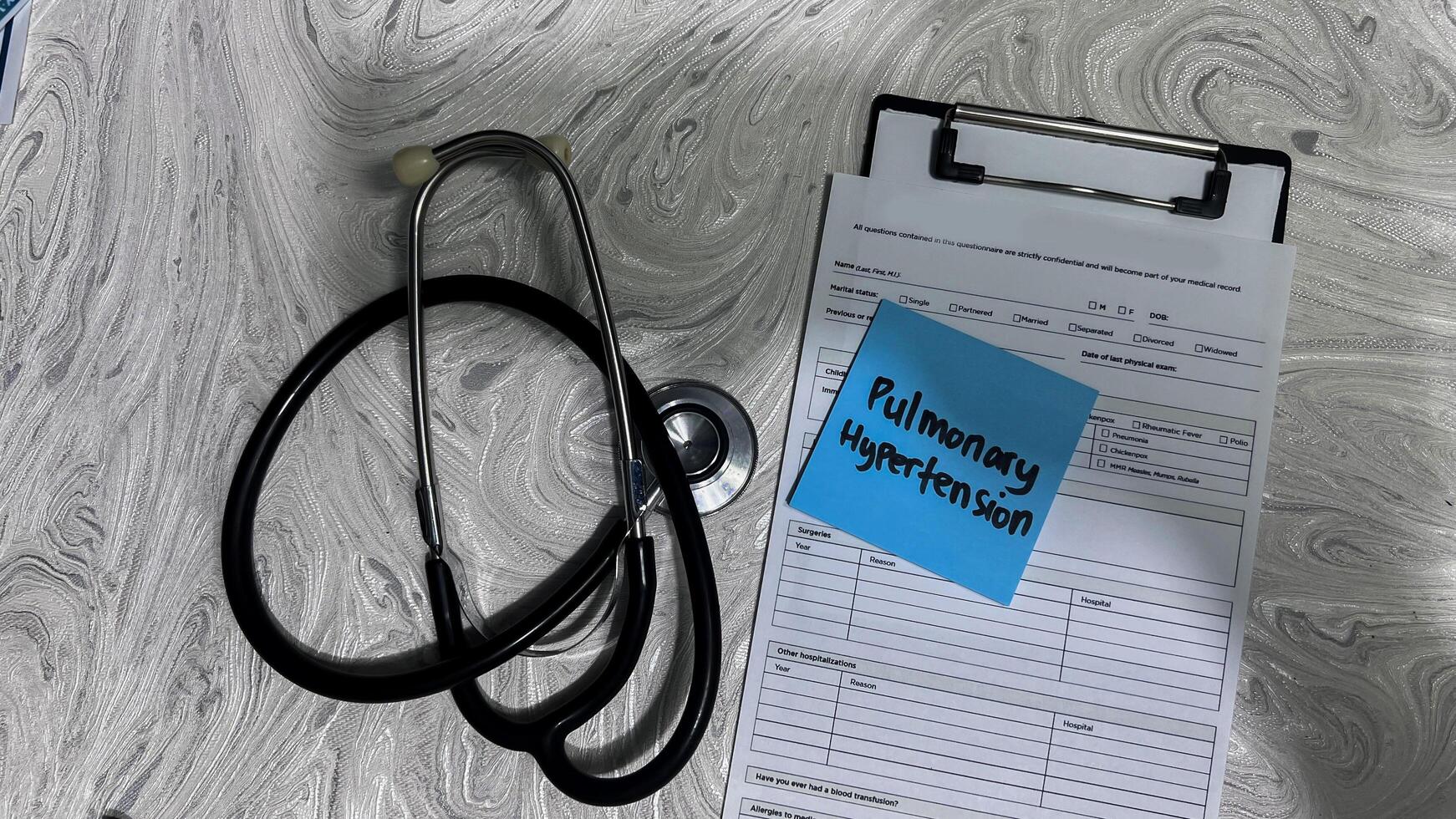 Concept of Pulmonary Hypertesion write on sticky notes isolated on Wooden Table. photo