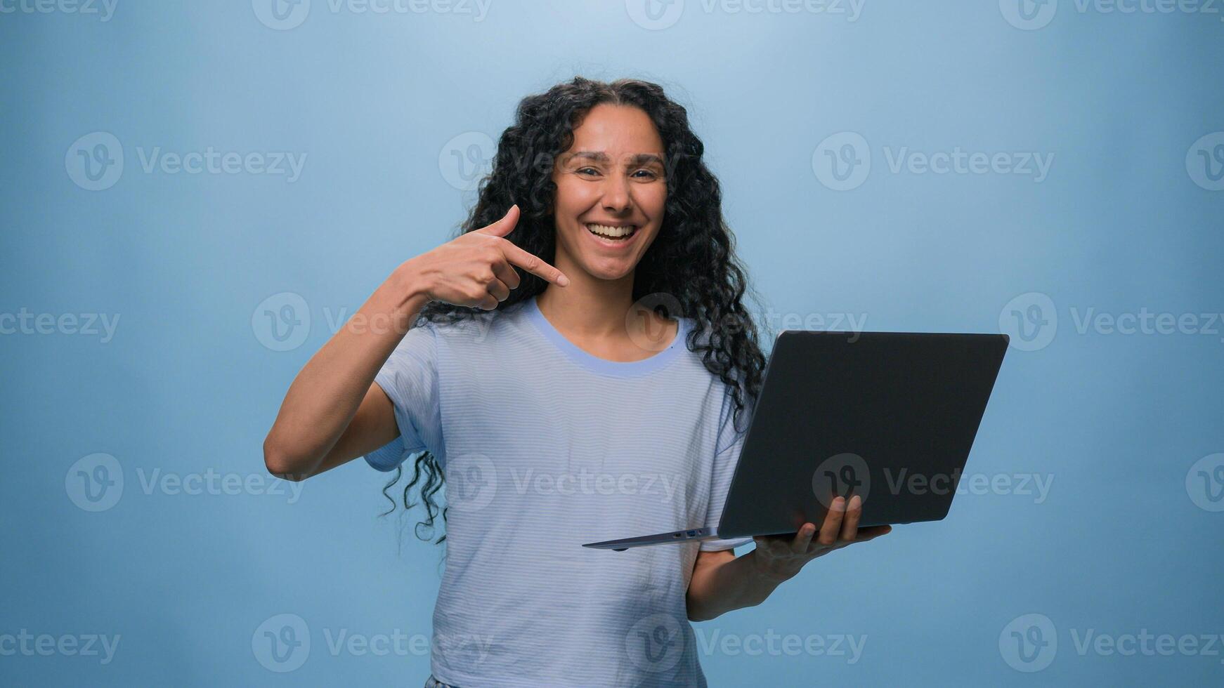 Excited woman female Latino student girl Hispanic user business win laptop online achieve victory computer bet good result champ efficient coding achievement level up bonus at blue studio background photo