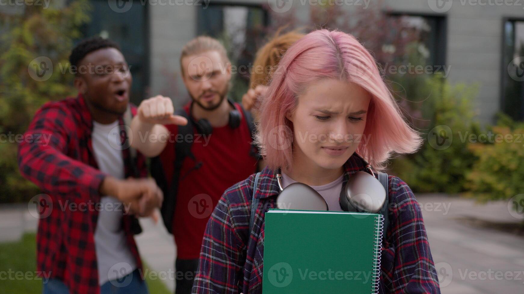Group multiracial students teens classmates showing thumb down mock abused humiliate bully Caucasian student woman bullied sad upset victim girl mockery high school bullying university college cruel photo