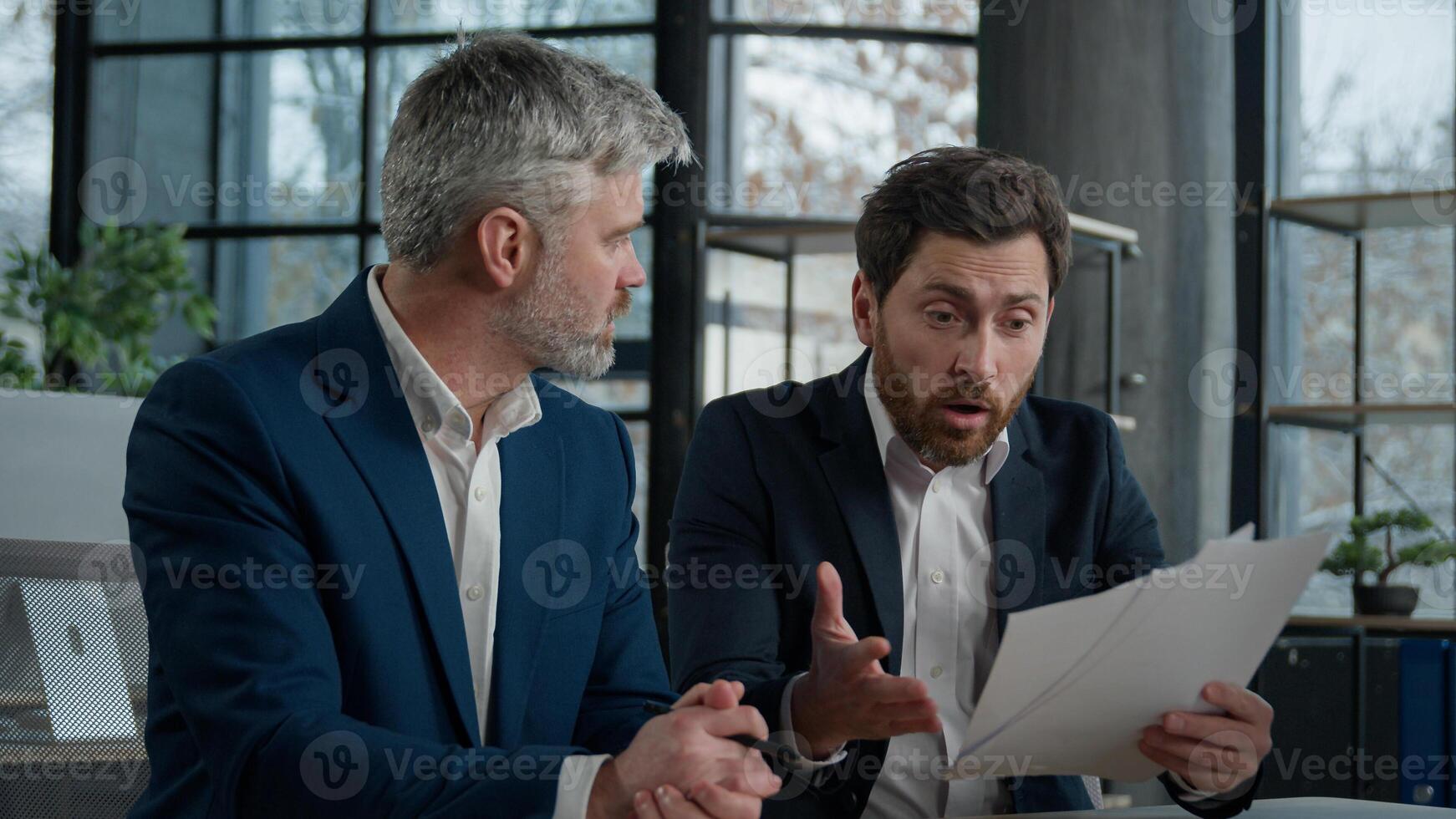 Nervous angry man boss argue scolds employee because mistake in documents financial papers Caucasian men businessmen arguing in office meeting business conflict problem mistake work failure bad result photo