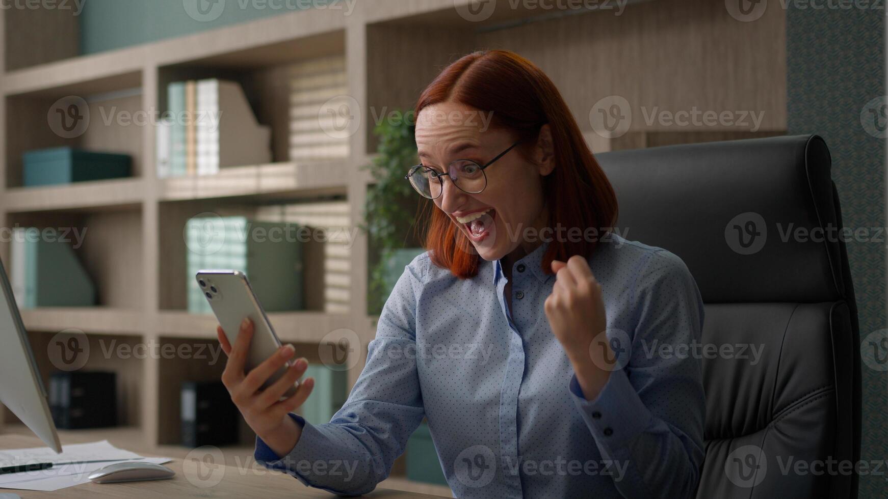 Happy excited female winner Caucasian woman business manager office worker girl businesswoman receive good news opportunity achievement prize notification win mobile phone winning smartphone victory photo