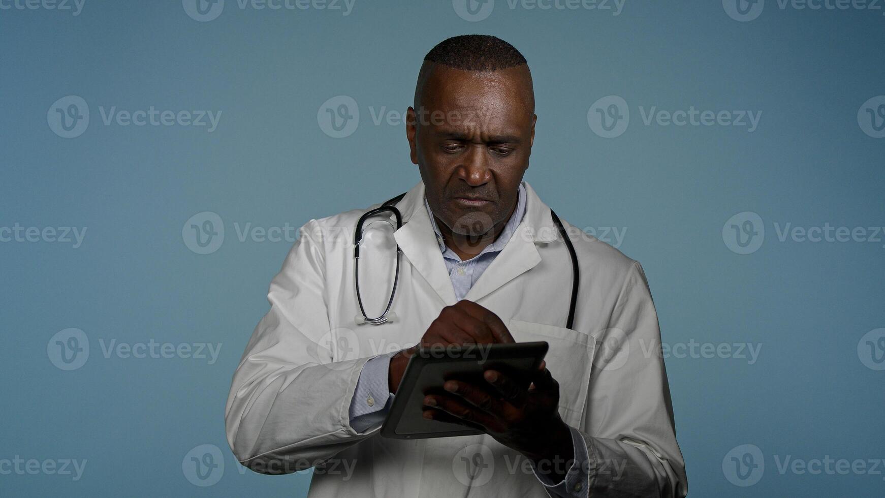 African American man professional doctor therapist consultant consulting patient using digital tablet for online appointment modern treatment read data analysis results use virtual medical application photo