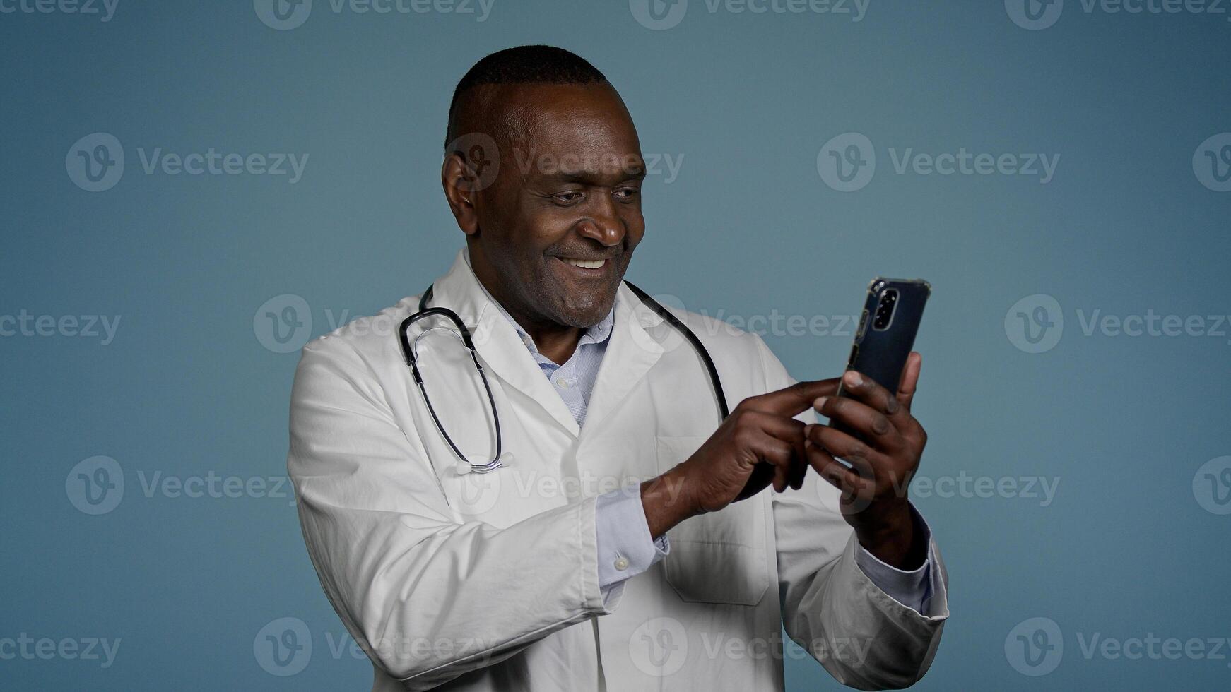 African American man doctor physician using medical virtual mobile application on phone remote browsing analysis results chat with patient on smartphone distance consultation medicine and modern tech photo