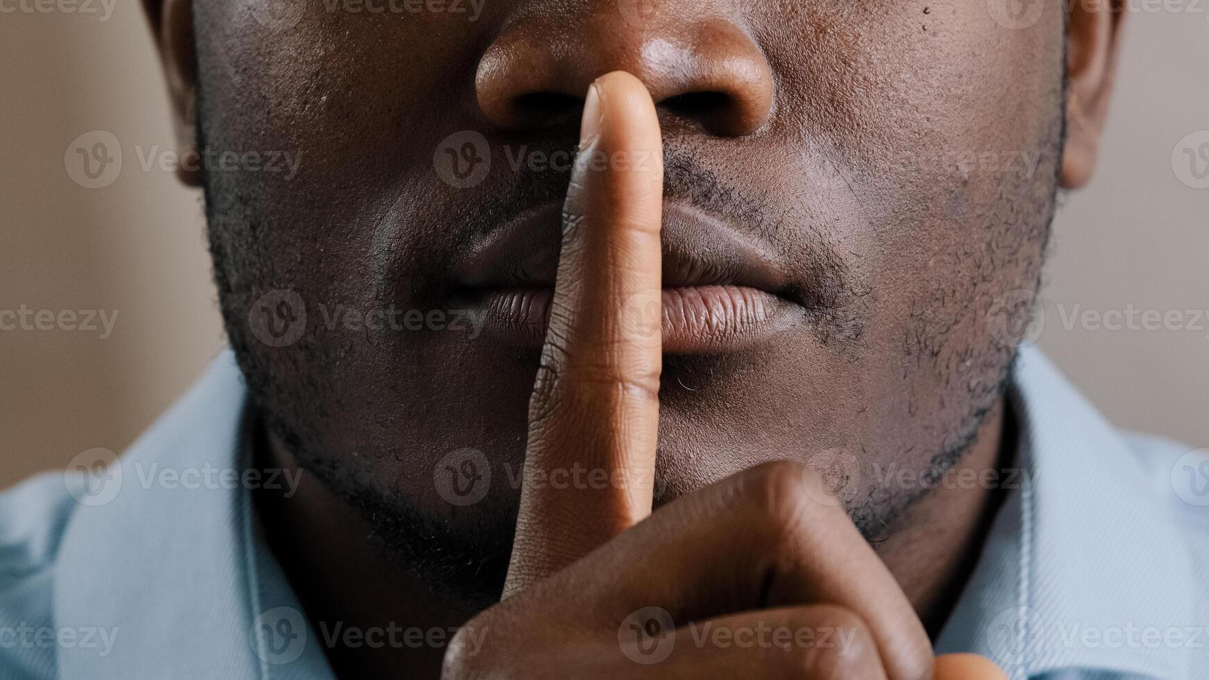 Mysterious unknown male face part african american adult man put finger to lips ask be quiet make gesture silence show secrecy sign keep secret confident information silent forbid tell close up view photo