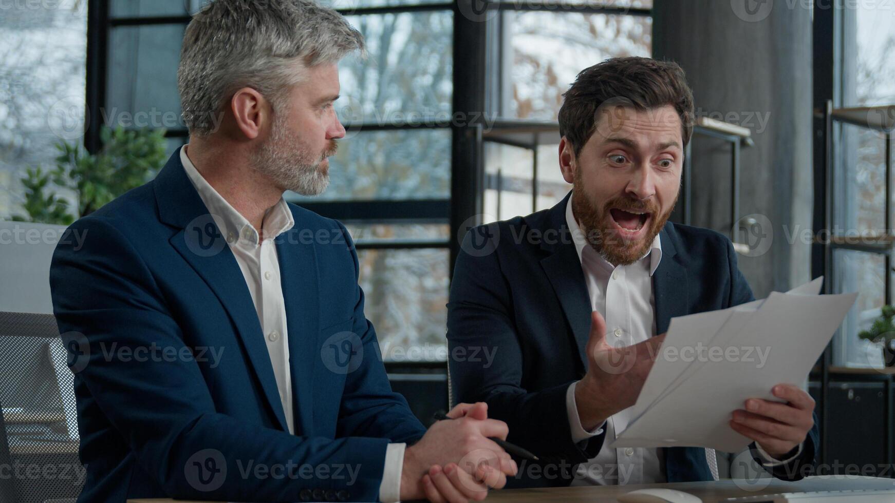 Nervous angry man boss argue scolds employee because mistake in documents financial papers Caucasian men businessmen arguing in office meeting business conflict problem mistake work failure bad result photo