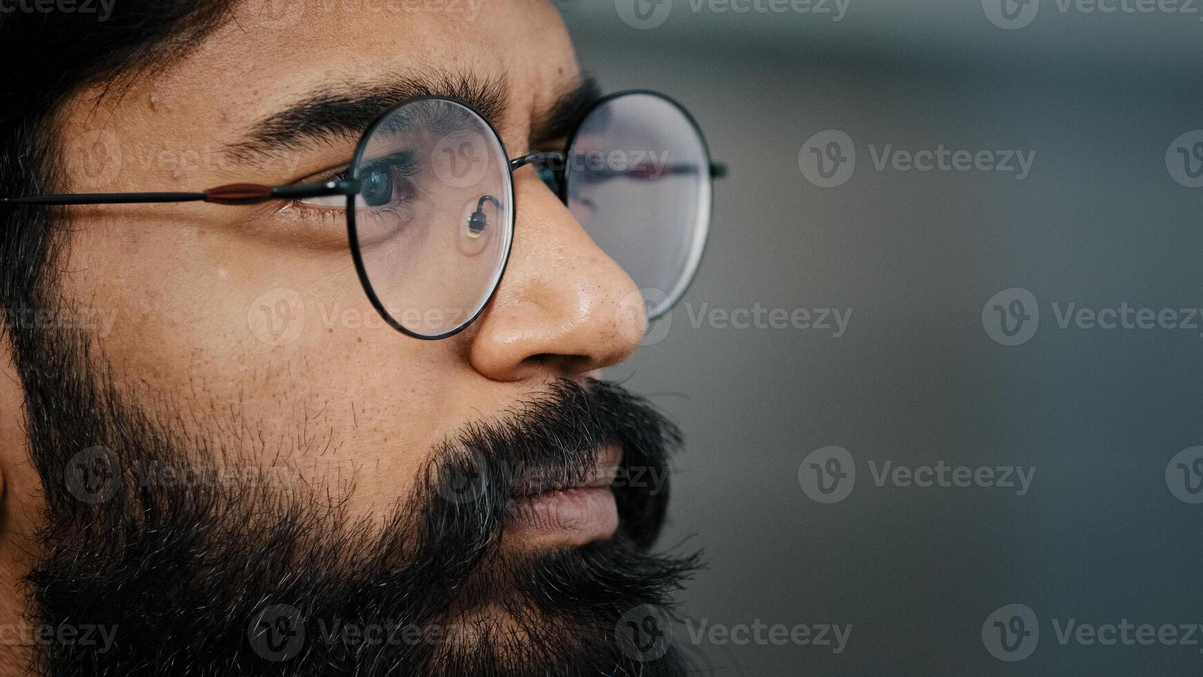 Close up profile face view portrait bearded thoughtful arabian boss entrepreneur business man in glasses indoor dreaming looking away lost in thoughts search ideas self-isolation due covid pandemic photo