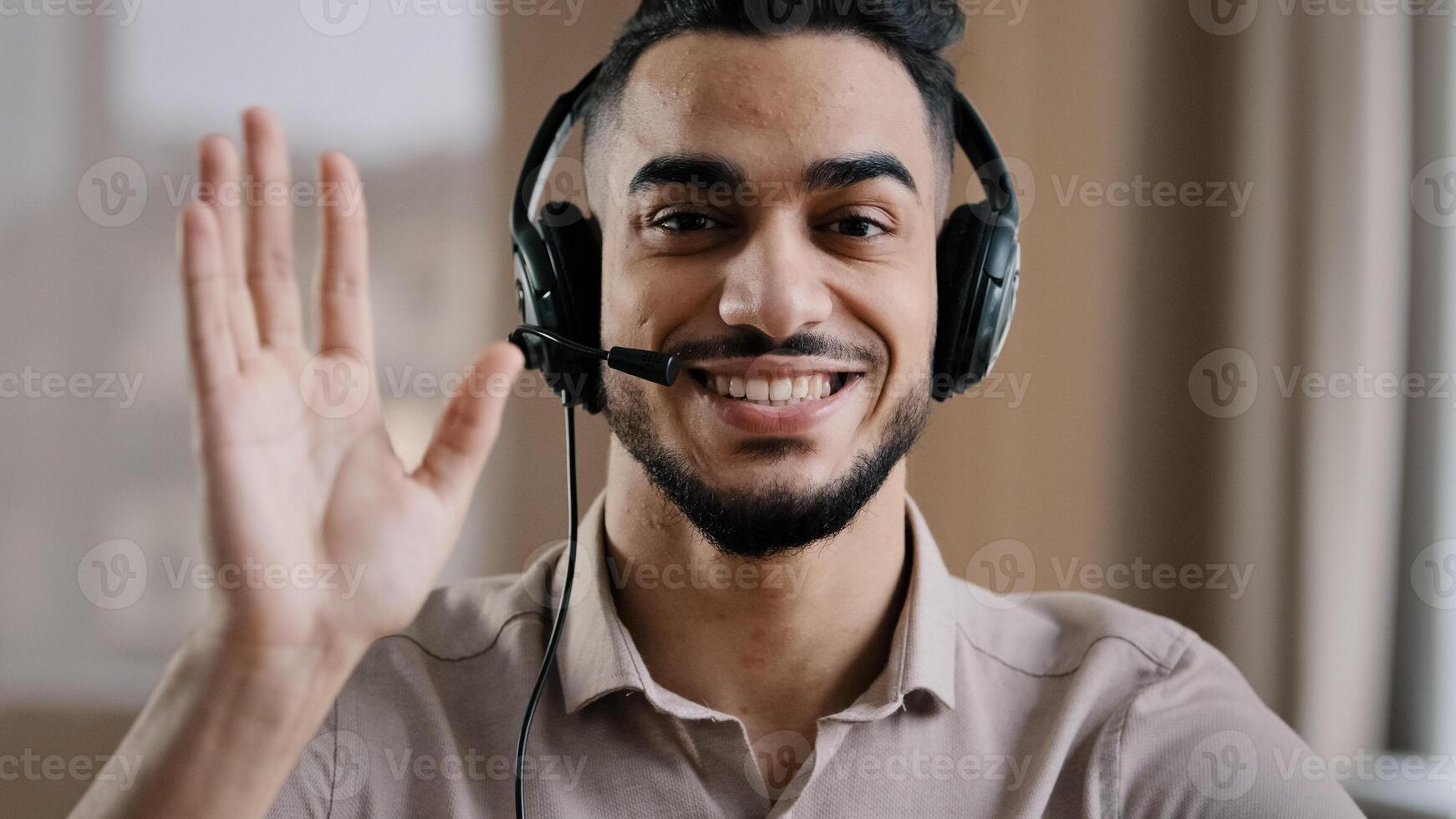 Smiling male operator hispanic businessman customer support service assistant representative greeting speak at web camera wear headset with microphone make conference call remote job interview photo