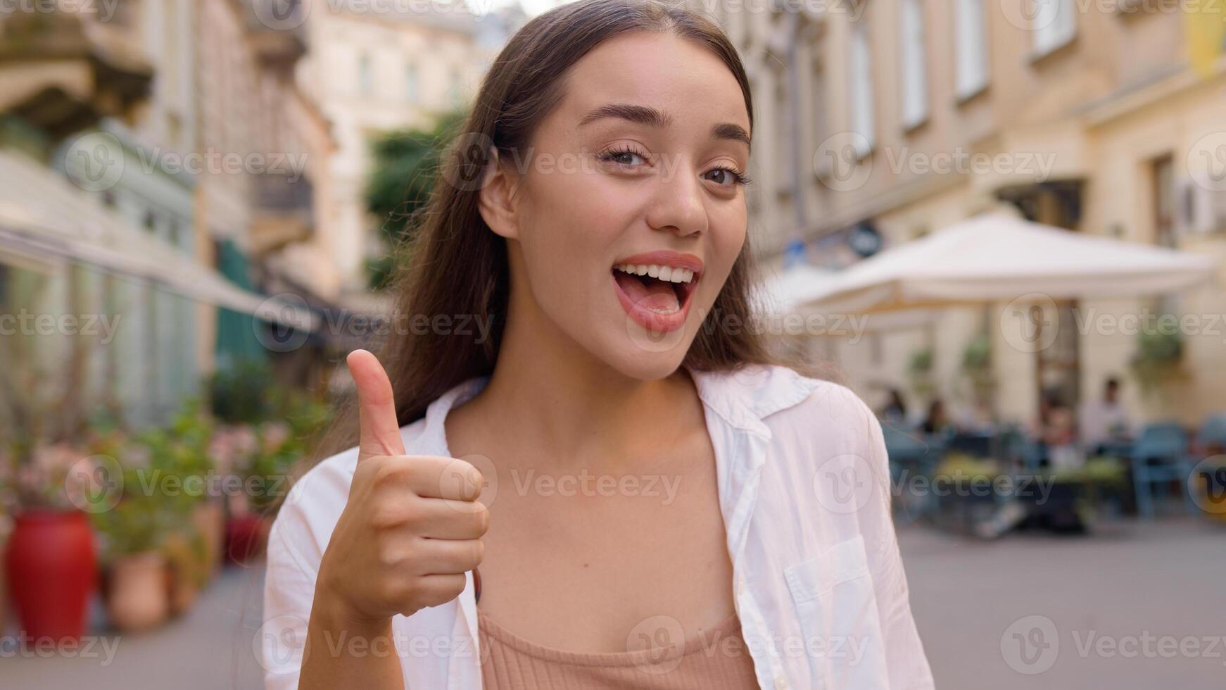 Happy caucasian woman smiling show thumb up. Enjoy happiness successful positive lady city street outside gesturing agreement young model agree winner carefree satisfied cheerful girl approval liking photo
