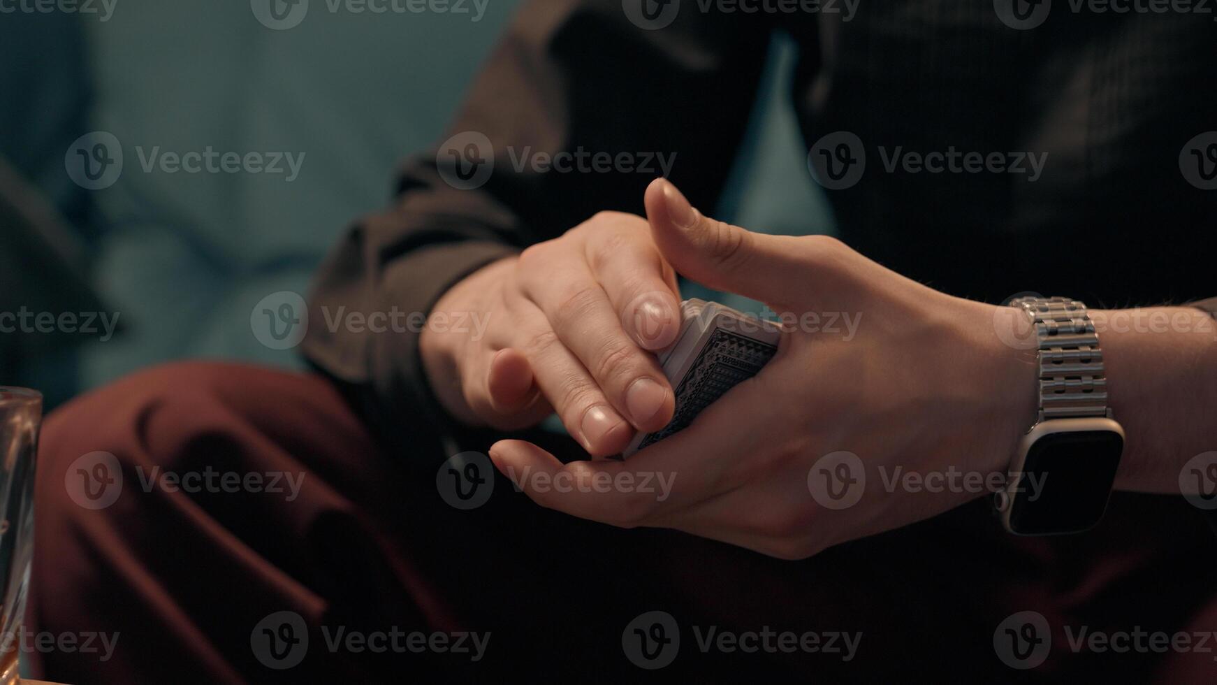 Unknown Caucasian man guy dealer gamer croupier male hands shuffles playing cards shuffling card poker skill play gamble weekend competition game at home casino. Addiction alcohol bad habits gambling photo