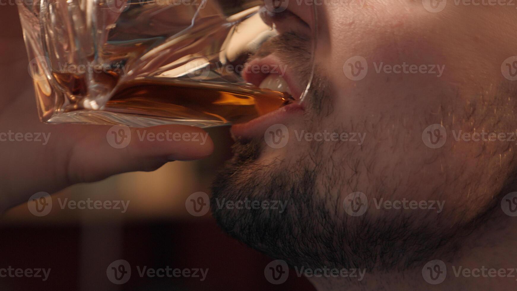 Close up happy laughing Caucasian drunk addict man male bearded businessman guy client customer drinking glass expensive alcohol liquor whiskey at home room. Alcoholism addiction unhealthy lifestyle photo