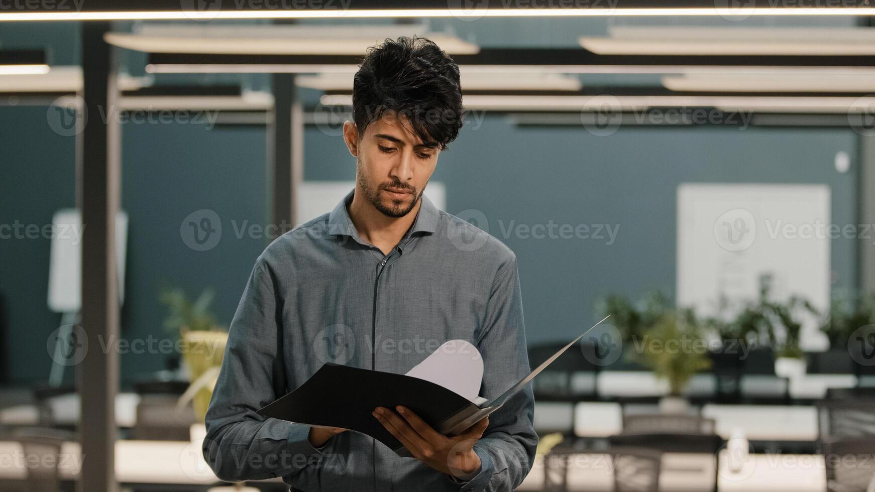 Shocked Arabian multiracial businessman feel stress checking business report paperwork man worries of financial problem company looking frustrated finding mistakes in documents budget loss bank debt photo