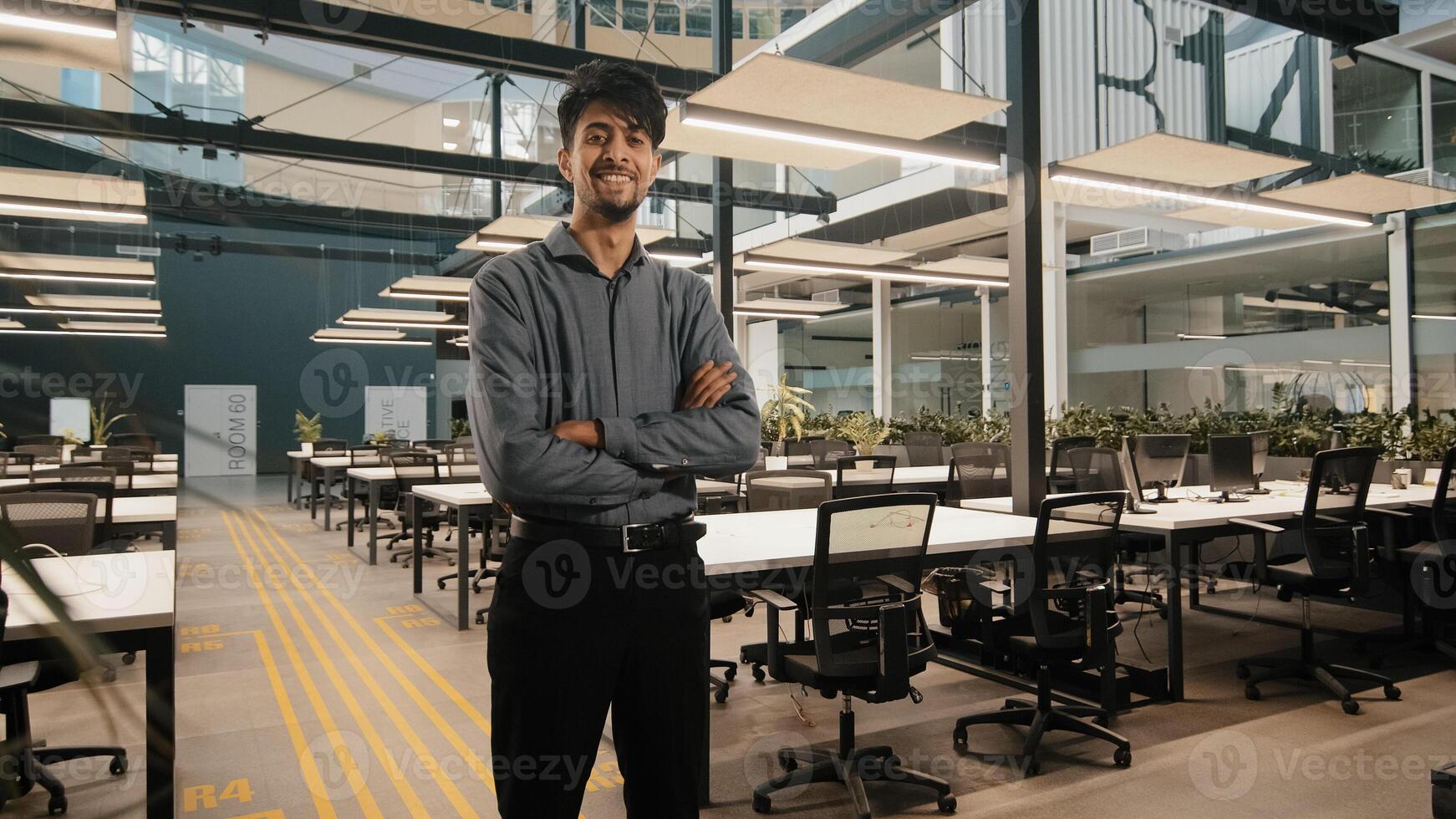 Indian male general office leader professional worker arab man businessman standing in office with arms crossed confident strong pose position project manager posing in workplace with crossing hands photo