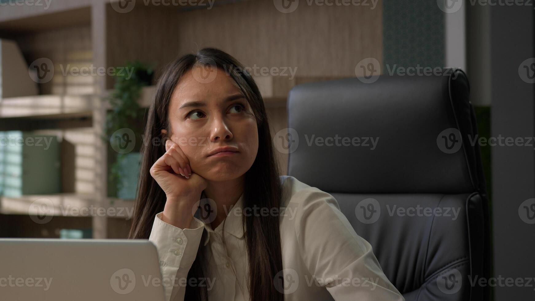 Thoughtful concerned Caucasian business woman working on laptop computer writing notes write document idea thinking solving problem at home office serious businesswoman girl search decision pensive photo