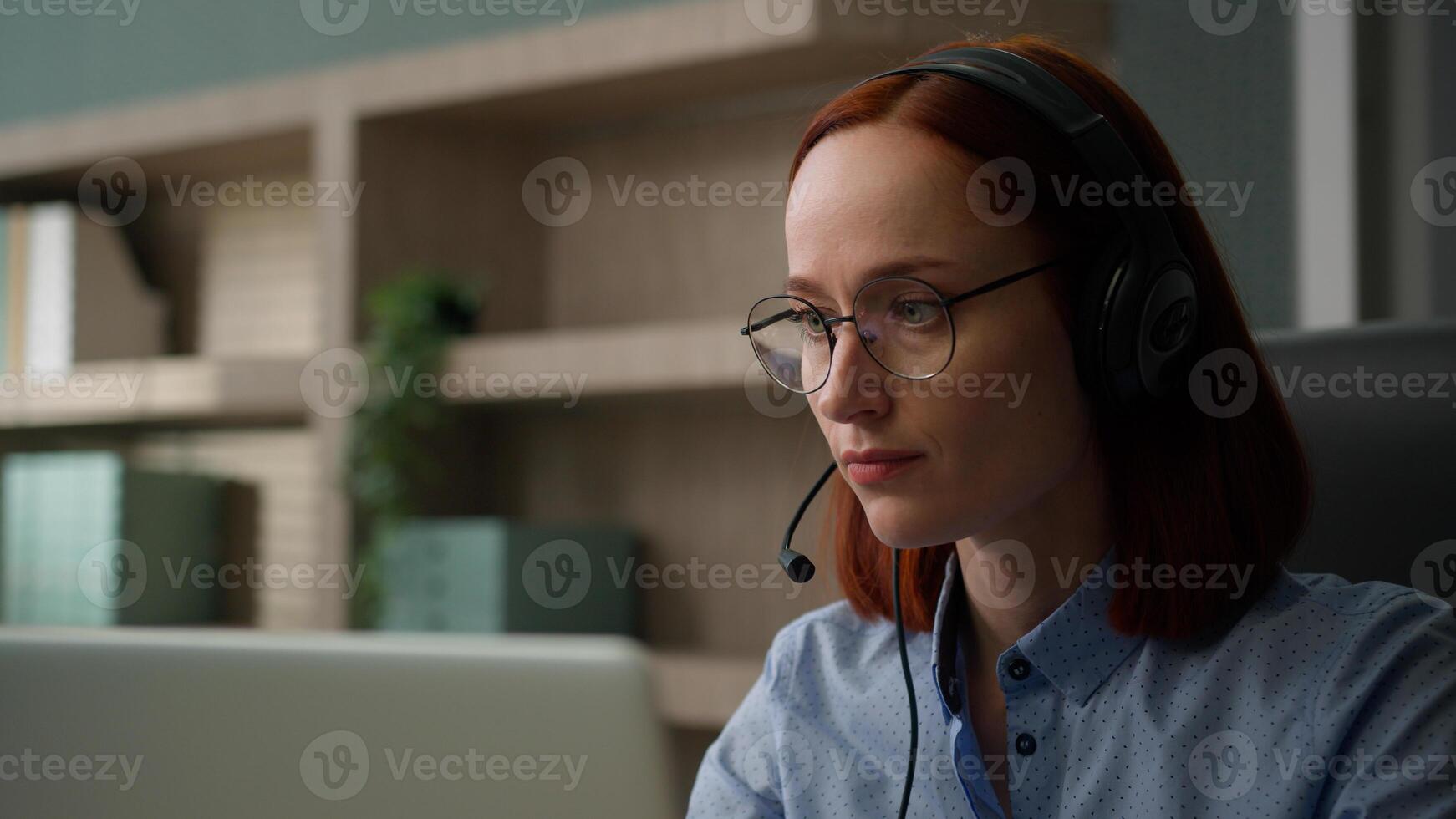 Caucasian business woman in headset communicate with clients solve problem female girl office worker conference call with laptop computer. Serious businesswoman speaking talk webcam distant chat photo