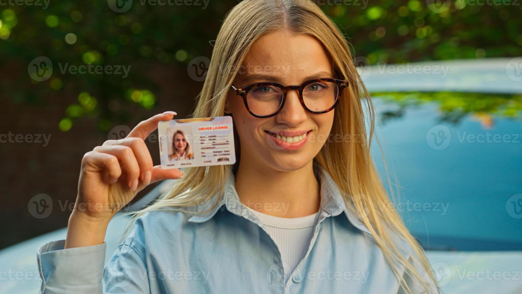 Caucasian confident woman wink smile achievement driver license document female girl owner driving school car showing happy education student auto transportation beginnings certificate insurance enjoy photo