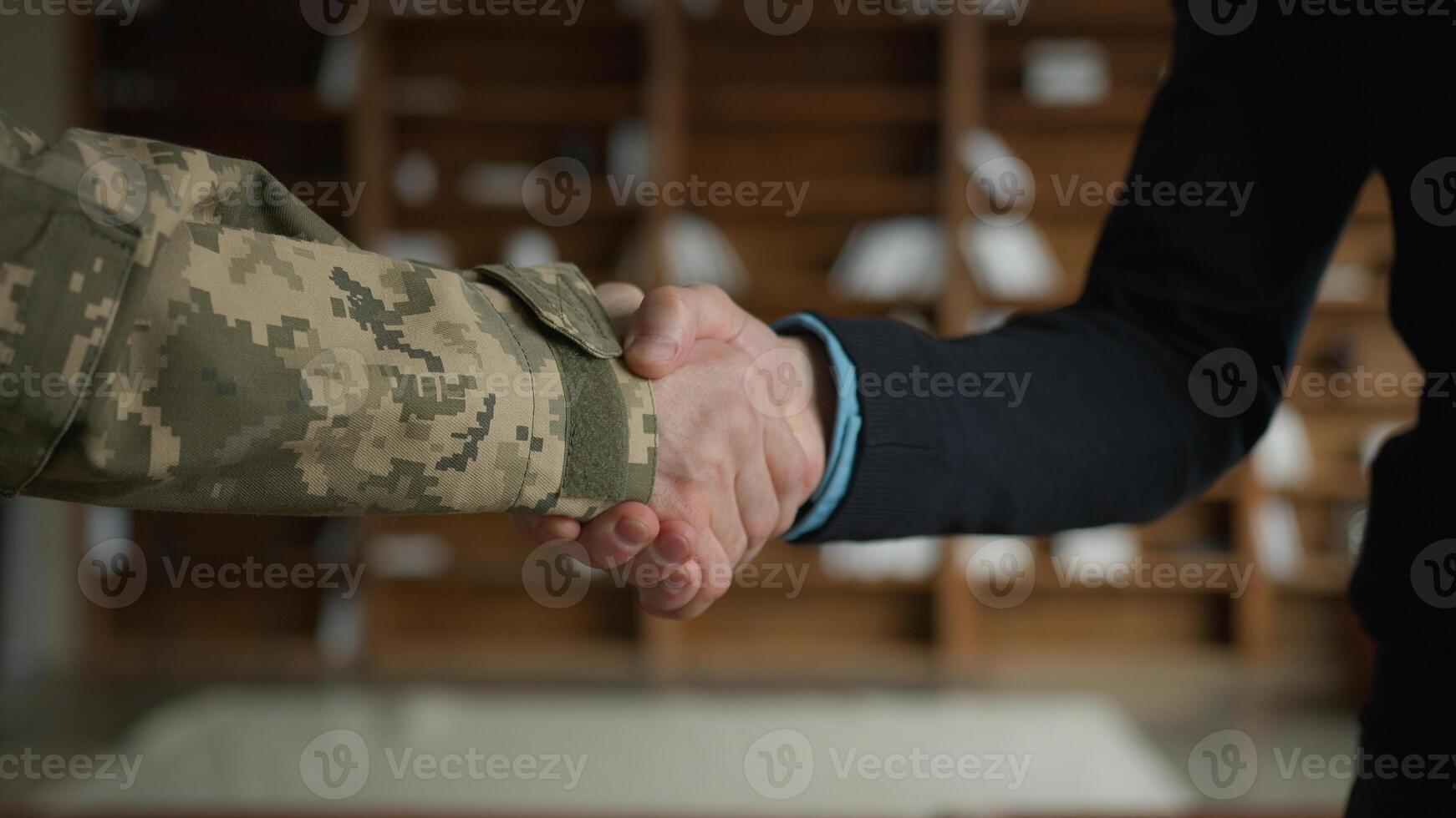 Close up male handshaking. Two unrecognizable men military soldier veteran warrior guy veteran officer grabbing arms shaking hands businessman entrepreneur gratitude respect greeting handshake indoors photo
