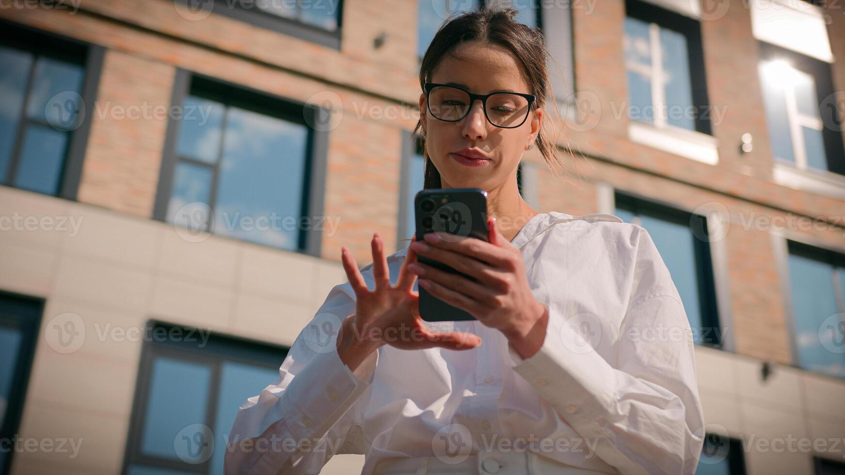 Confused Caucasian woman using mobile phone outdoors downtown girl businesswoman search street looking around city browsing social media use smartphone geolocation navigation exploring business center photo