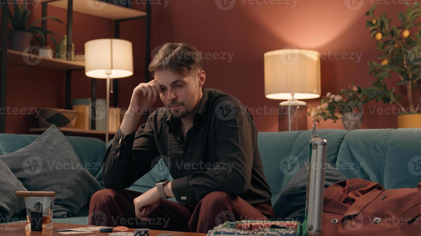 Worried anxious nervous Caucasian man male guy player gambler thinking rubbing hands praying gesture anxiety playing poker game betting risk wager gambling unhealthy lifestyle addiction casino at home photo