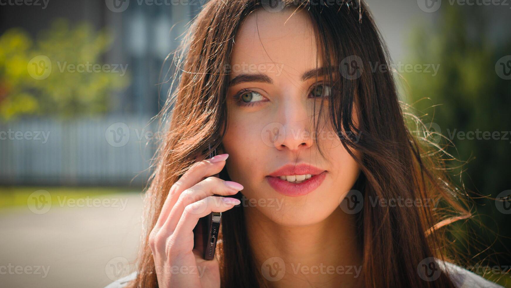 Close-up woman businesswoman student talking on mobile phone outdoors girl client remote make order using smartphone on street speak friend answering business call talk on cellphone female portrait photo