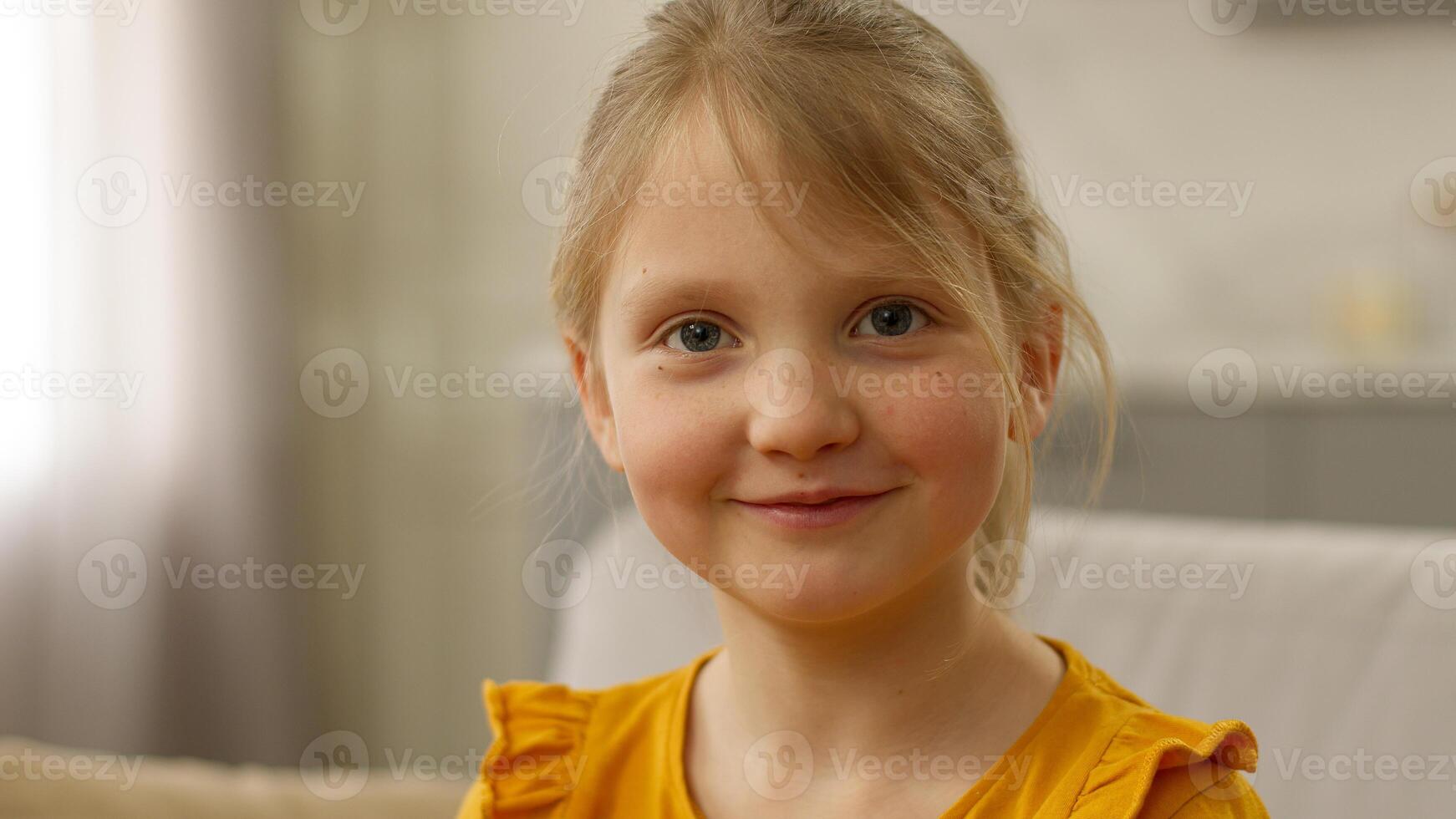 Close up European little happy girl looking at camera smiling laughing joy enjoying child daughter kid childhood glad satisfied delighted pleasure positive expression funny innocence face offspring photo