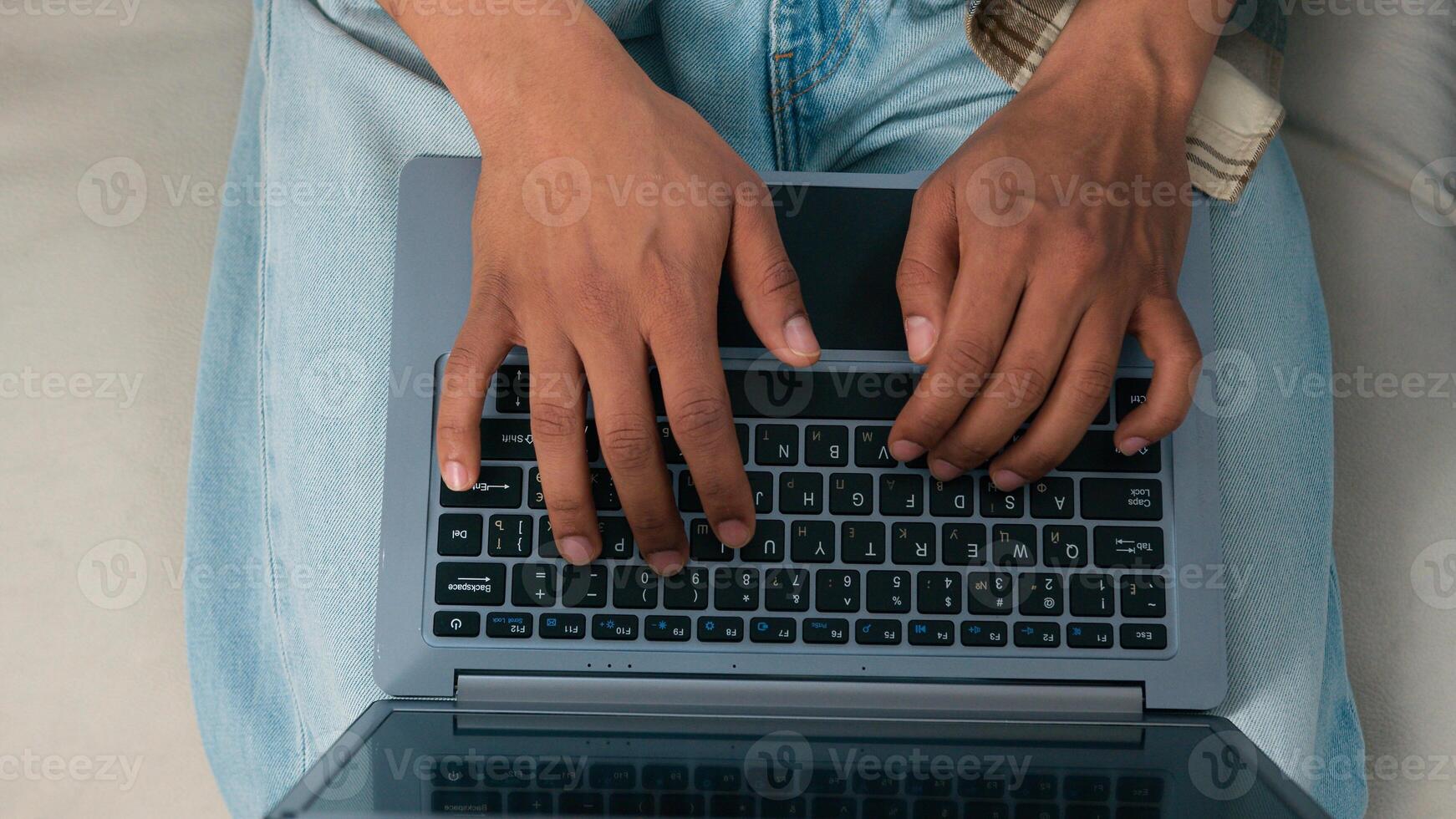 Top view moving shot unrecognizable African American woman work laptop man job online computer couple working at home couch sofa office two colleagues coworkers users typing two pc computers coworking photo