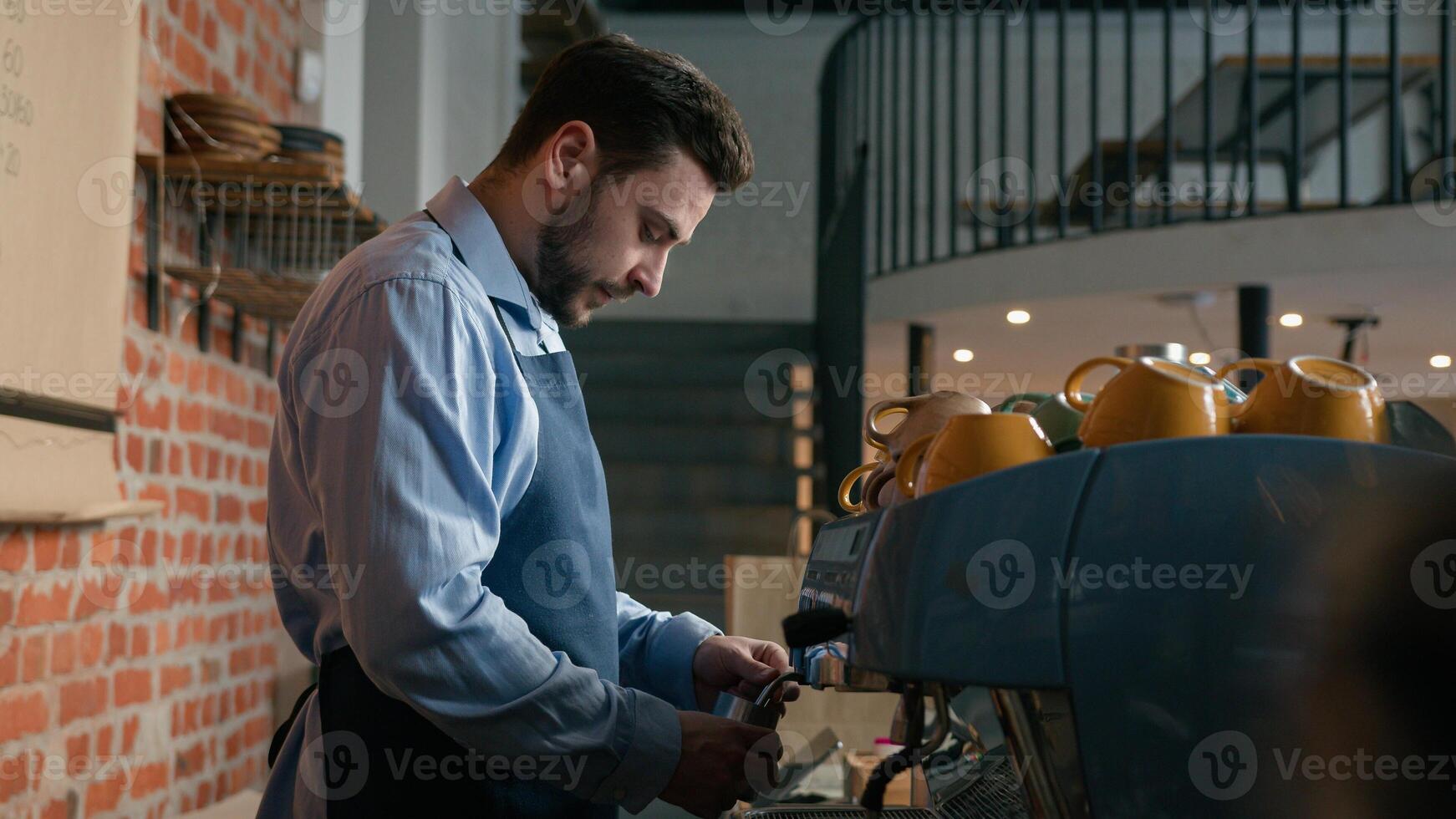 Smiling caucasian man waiter professional barista bartender make coffee behind counter in cafeteria serve customer in restaurant happy male cafe employee staff small business owner looking at camera photo