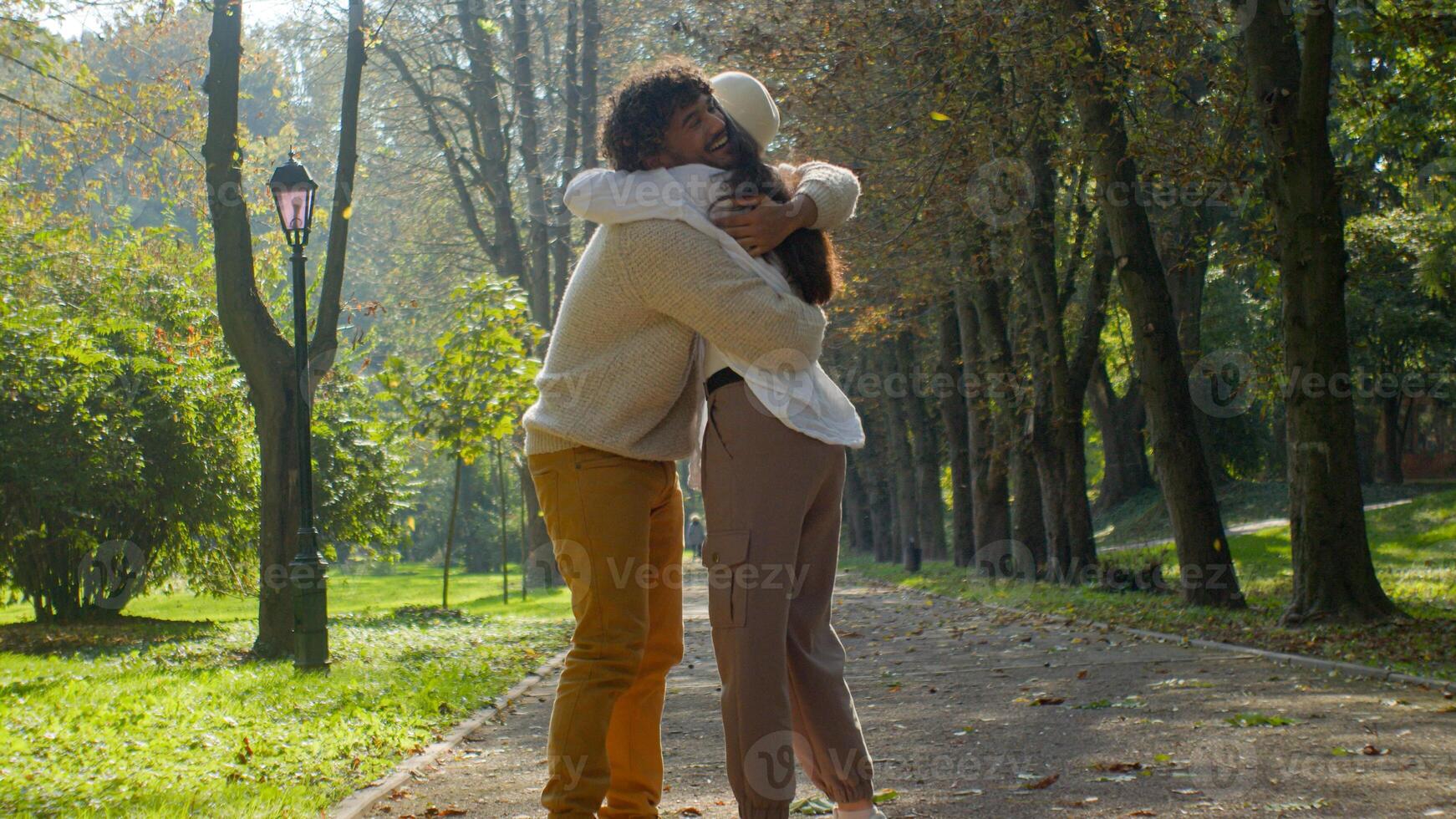 Happy Indian Arabic married couple in love glad girl female male boy hugging in park outdoors woman man cuddle romantic relationship girlfriend embrace boyfriend touch husband wife enjoy date holiday photo