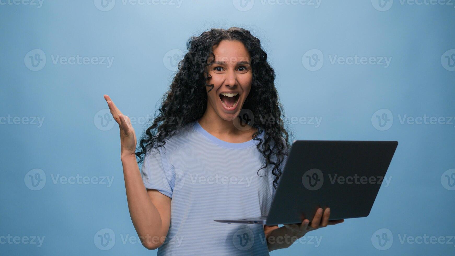 Excited woman female Latino student girl Hispanic user business win laptop online achieve victory computer bet good result champ efficient coding achievement level up bonus at blue studio background photo