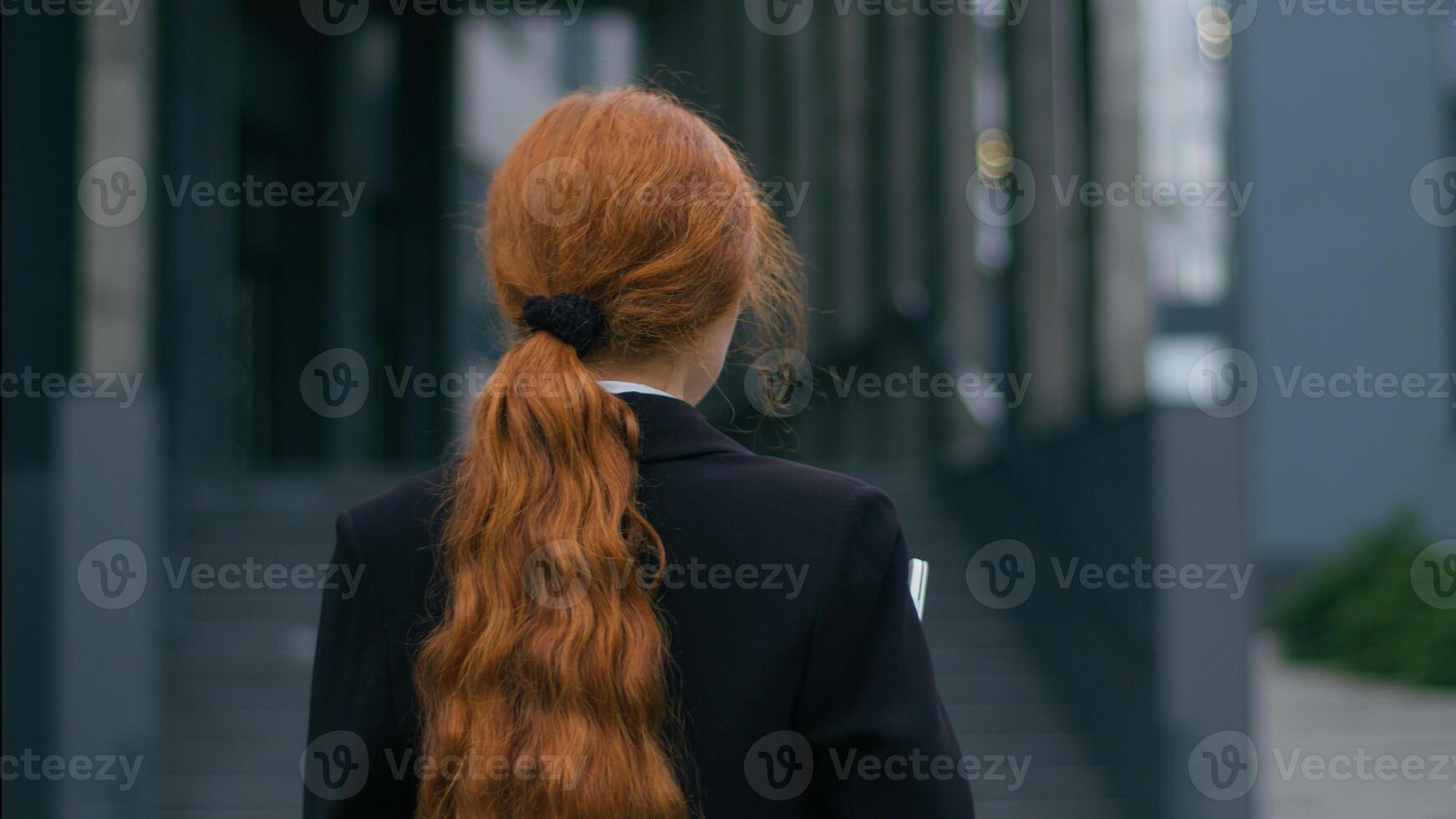 Happy smiling joyful Caucasian young female business woman girl employee CEO holding laptop device posing outside. Positive attractive businesswoman turning looking at camera wide smile outdoors city photo
