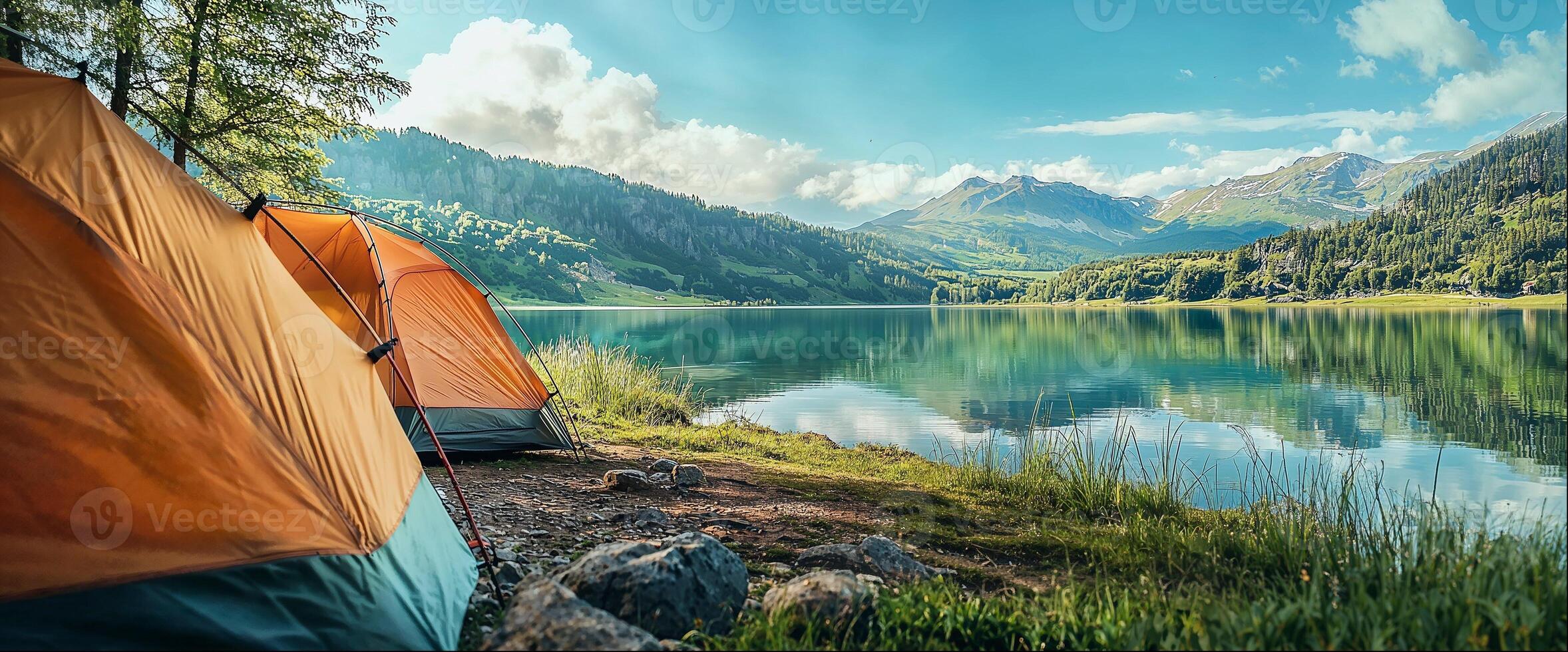 Tourist tents on shore of clear mountain lake close-up, beautiful natural landscape with copy space photo