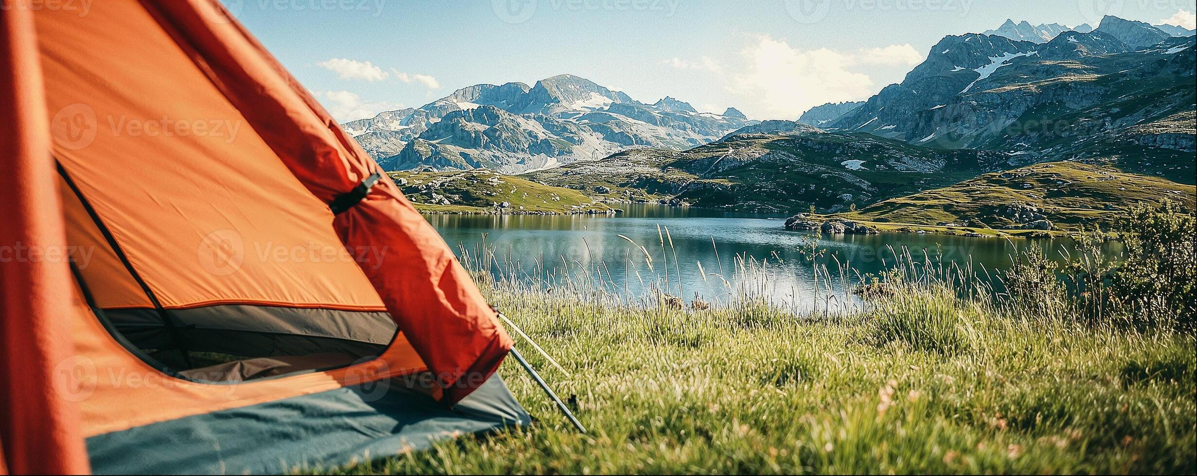 Tourist tents on shore of clear mountain lake close-up, beautiful natural landscape with copy space photo