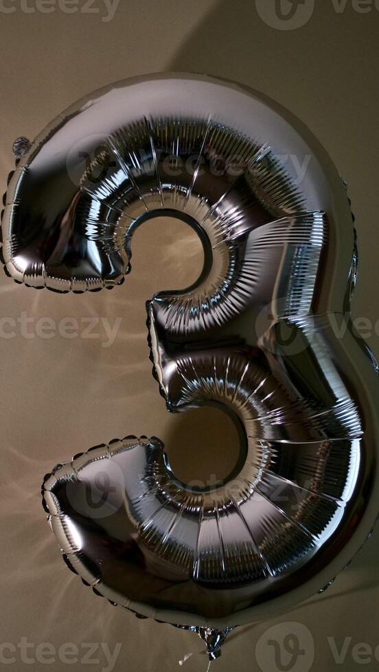 Party Happy Birthday Three with Silver Grey number . Gel balls 3 for congratulations celebrations holiday. Close-up, no people, vertical photo