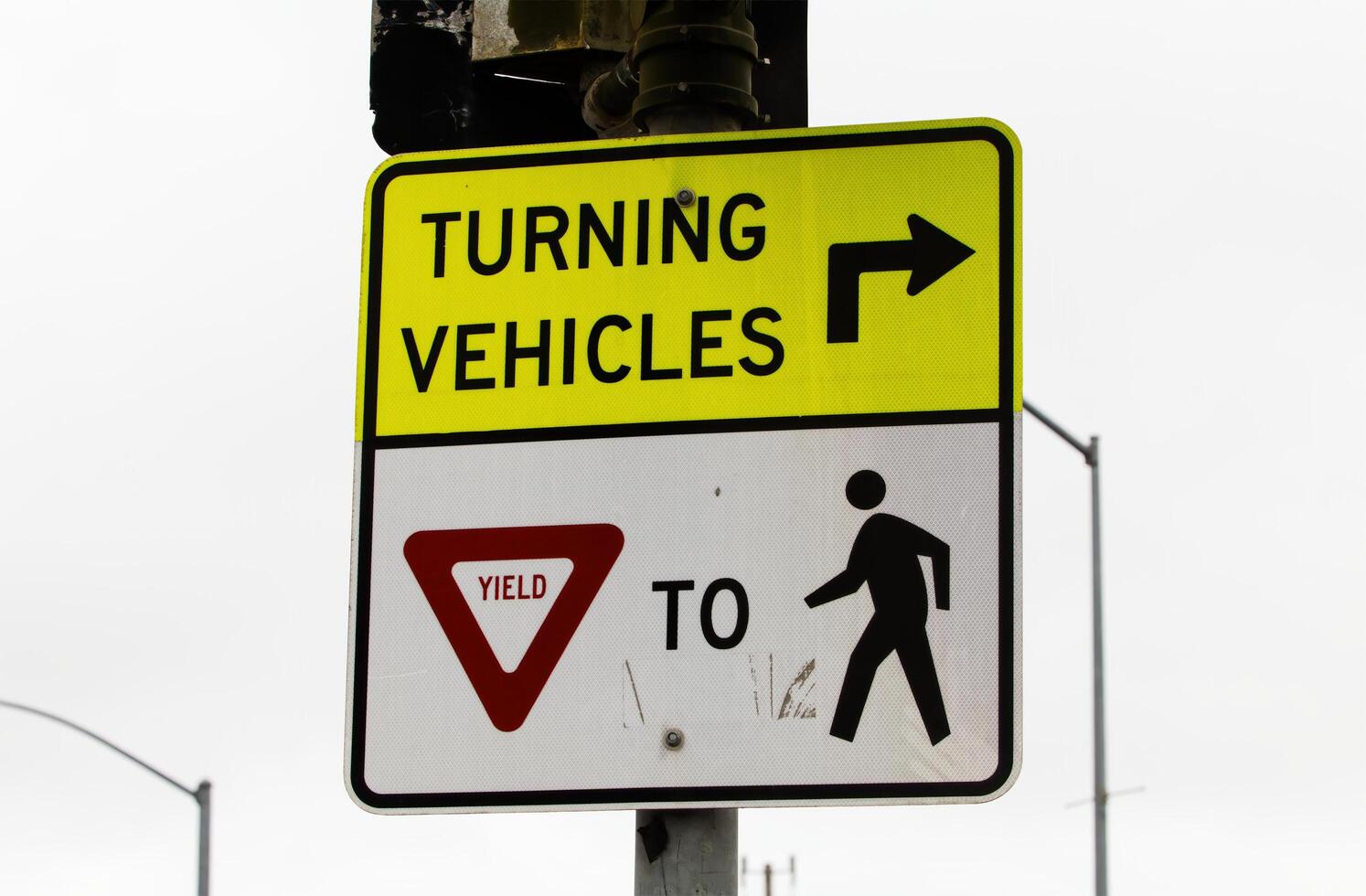 Watsonville, CA, 2024 - Yield To Pedestrians Traffic Sign With Overcast Sky photo