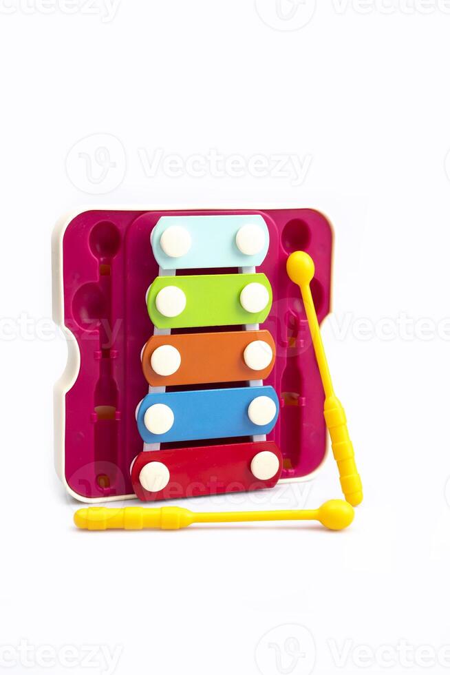 Colored toy educational xylophone with two sticks on a white background. children's musical instrument photo