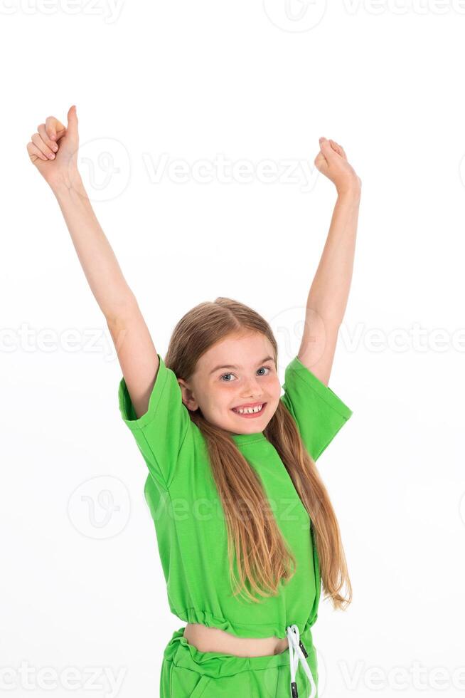 Portrait of adorable emotional winners little girl in green t-shirt isolated on a white photo