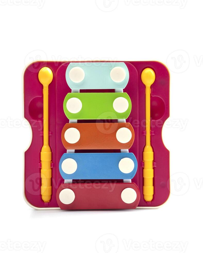 Colored toy educational xylophone with two sticks on a white background. children's musical instrument photo