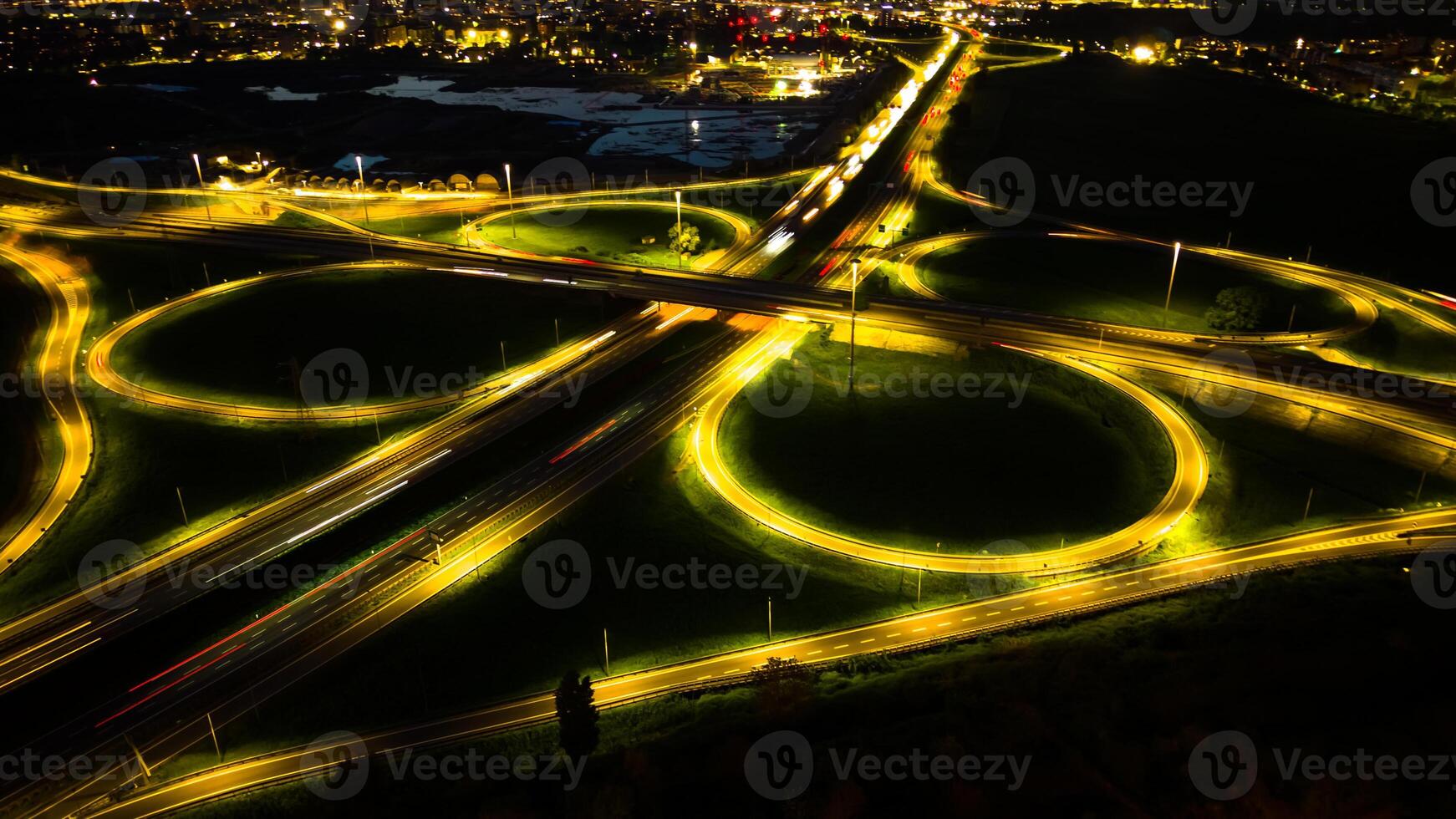 Aerial view huge multi-lane circle roundabout intersection in city traffic highway night city. Public transport commuter pollution business concept. Milan, Italy. photo