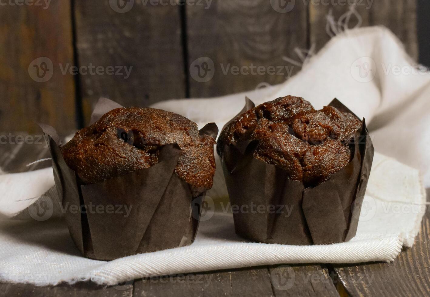 Chocolate muffins on wood background photo