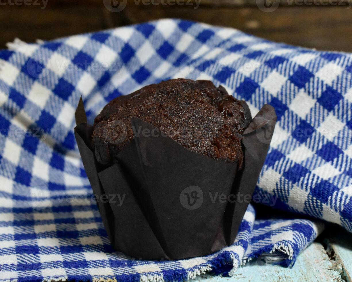 Chocolate muffins on wood background photo